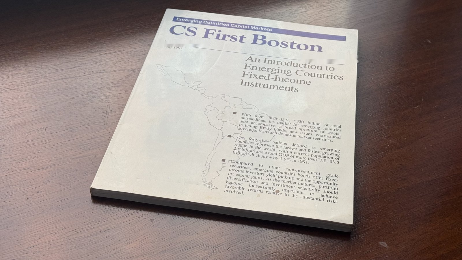 The cover of An Introduction to Emerging Countries Fixed-Income Instruments, the emerging-markets handbook published by CS First Boston in 1993, resting on a desk.